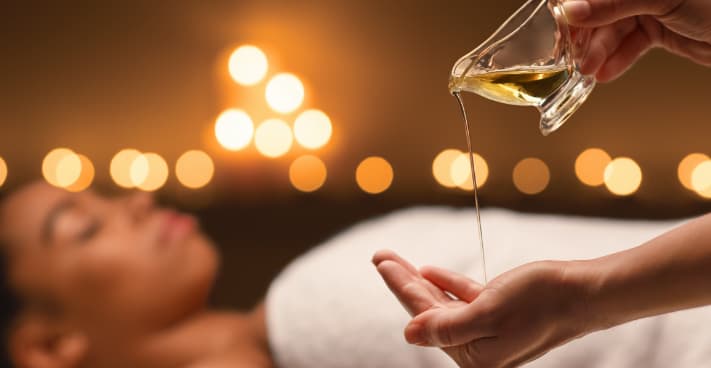 oil massage therapist with massage oil
