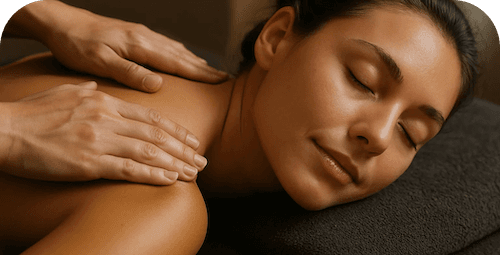 Person laying on a table receiving a back massage Person laying on a table receiving a back massage