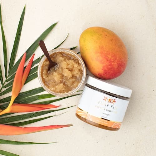 Fruit and leaves with a container of Coconut Sugar Rub Fruit and leaves with a container of Coconut Sugar Rub